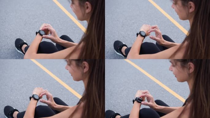 女运动员在锻炼后查看她的智能手表上的进度