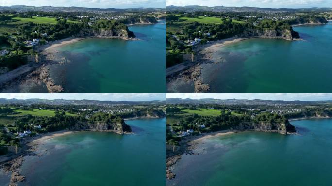 4K:英国康沃尔郡海岸线的空中无人机视频。在圣奥斯特尔附近的海滩上绕圈飞行。库存视频剪辑素材