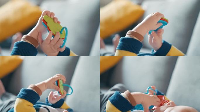 小男孩躺在家里的沙发上玩五颜六色的玩具