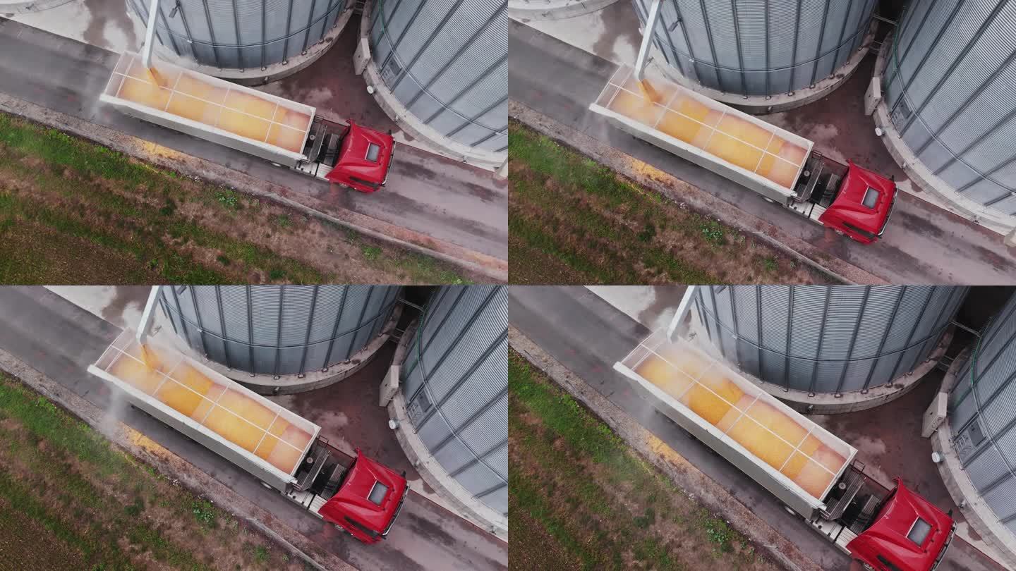 慢动作无人机拍摄谷仓填充拖车卡车在农村农场