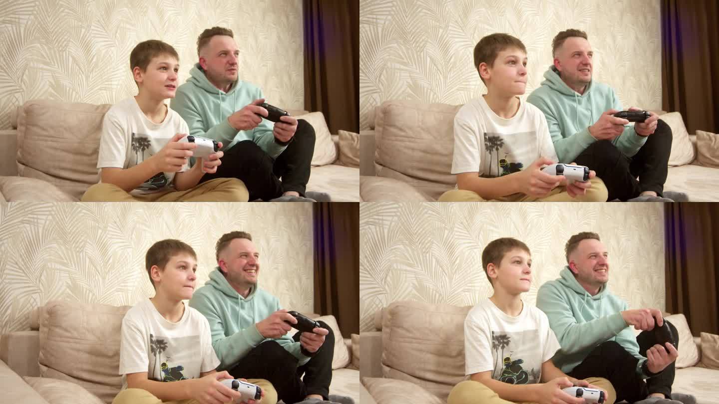 一位父亲和他的小儿子坐在沙发上玩游戏机。周末活动，空闲时间，家庭娱乐和视频游戏的概念。