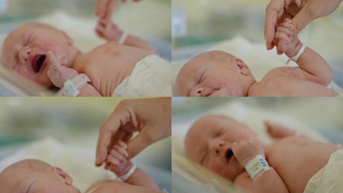 CU连接的心:母亲的手拥抱新生婴儿的小手指