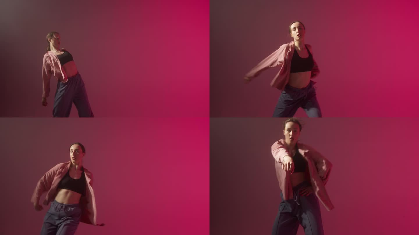 迷人的女人穿着高跟鞋，在粉红色的霓虹灯背景下跳着爵士放克舞。拍摄现代舞动感灵活的编舞。女舞者用塑料动