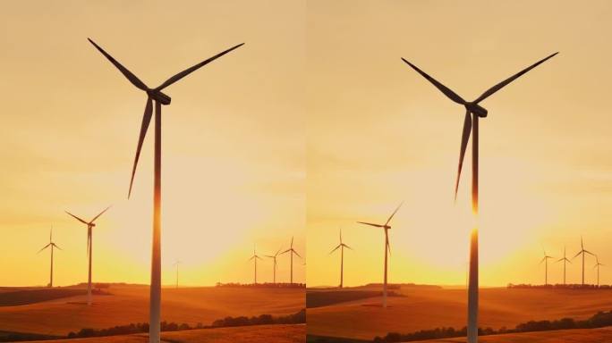 空中乡村复兴:日落无人机镜头捕捉风力涡轮机，田地，和一辆汽车走向清洁能源