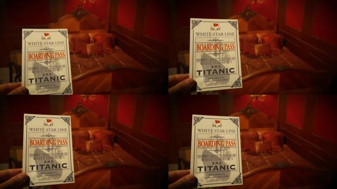 1912年，一名男子在泰坦尼克号的房间里举着泰坦尼克号的登机牌