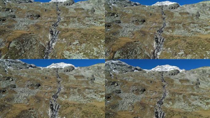 瀑布和山脉景观在齐勒塔尔阿尔卑斯山，奥地利-空中4k基座