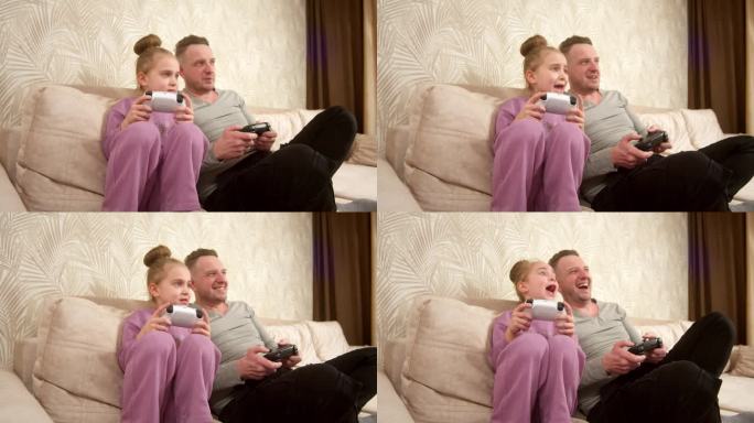 一位父亲和他的小女儿坐在沙发上玩游戏机。周末活动，空闲时间，家庭娱乐和视频游戏的概念。