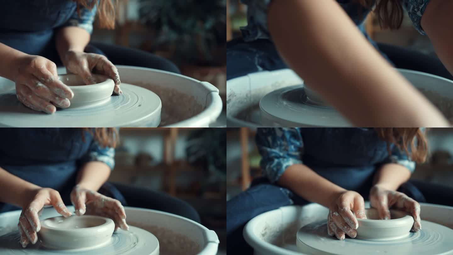 在陶艺工作室，女人的手用水在纺车上塑造粘土的特写
