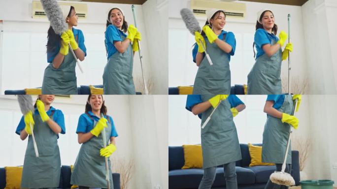 下图两个亚洲女管家或女佣站在一起，拿着清洁房子的工具，快乐地跳舞。