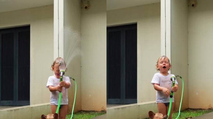 用花园洒水器给自己洗澡的顽皮小孩，滑稽的脸