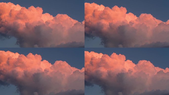 夕阳下，蓝蓝的天空上飘着鲜艳的橘红色蓬松的云，变化着形状，变换着造型