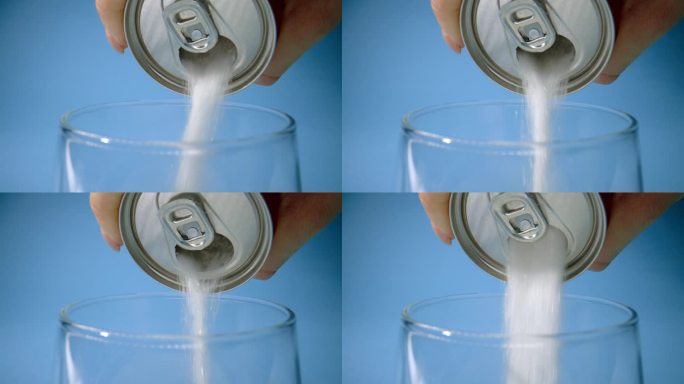 从汽水罐中倒出大量的糖到玻璃杯中，比喻提神饮料的含糖量