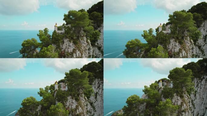 女子在充满活力的悬崖绿洲俯瞰大海，以莲花的姿势冥想。阳光洒在卡普里岛的悬崖上，展现了大自然真正的辉煌