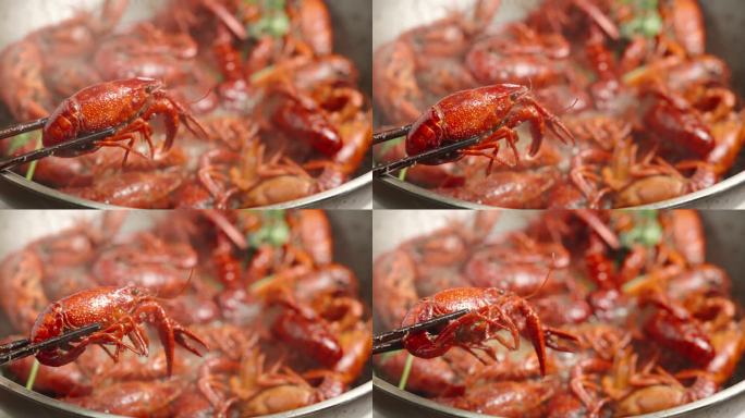 筷子夹起小龙虾夜宵美食特写