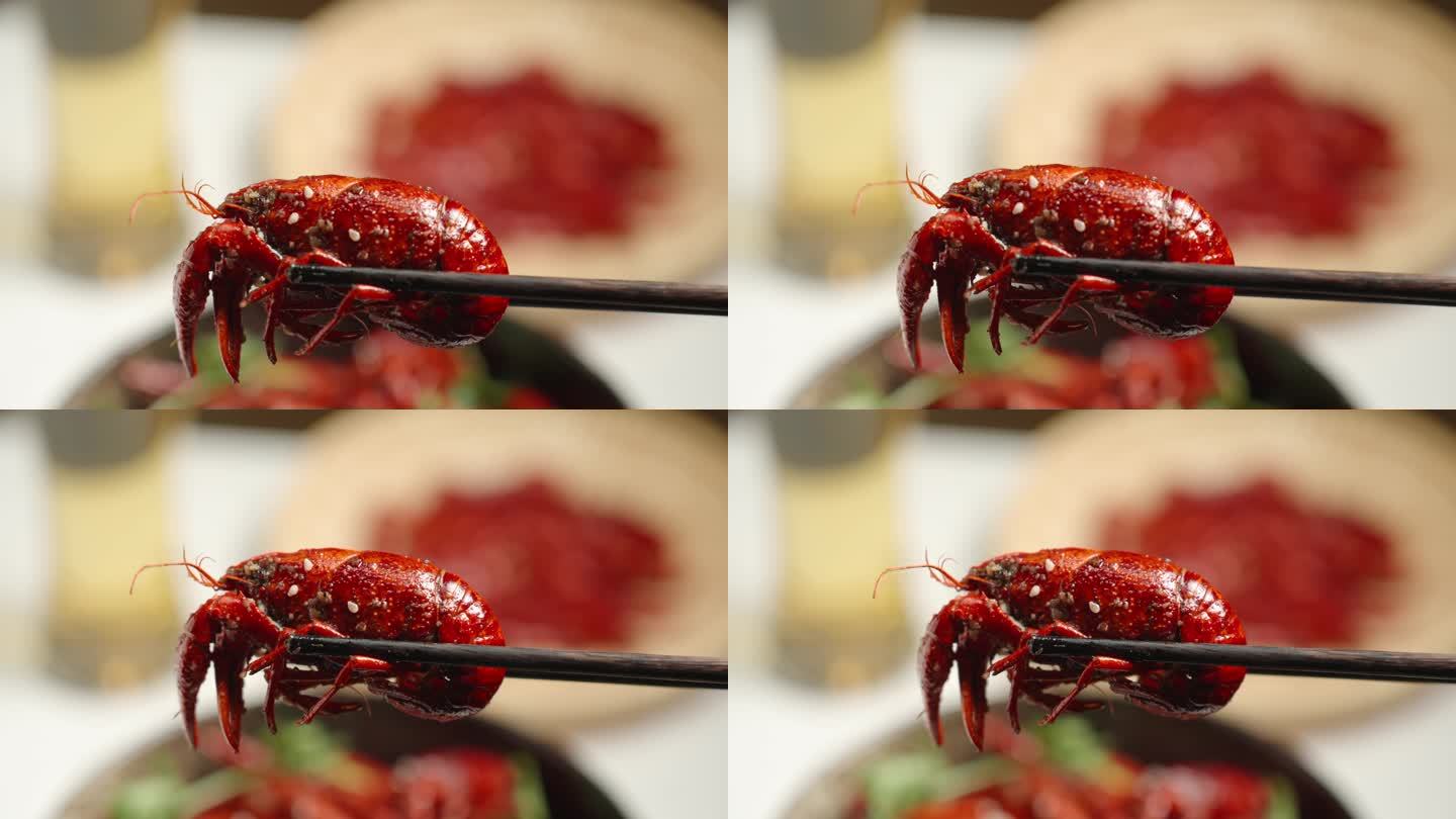 筷子夹起小龙虾夜宵美食特写