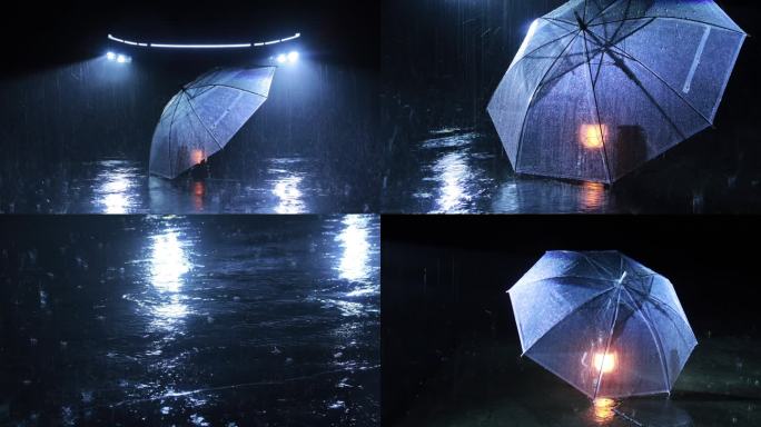 车灯前大雨中的雨伞