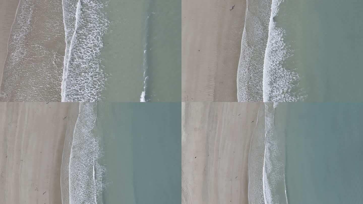 4K航拍从海浪拍岸拉高看见清澈沙滩海岸