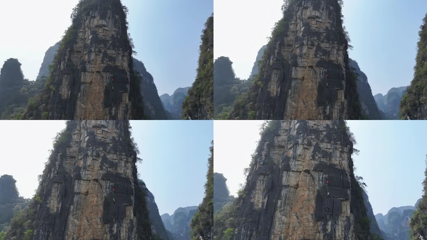 航拍攀登桂林阳朔拇指峰岩壁的结组攀岩者