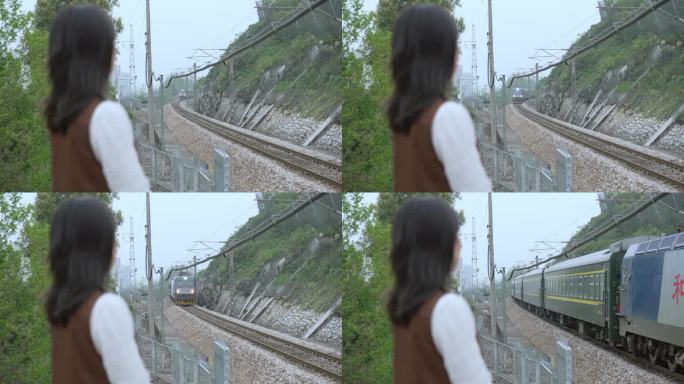 女孩站在铁路旁 绿皮火车试过