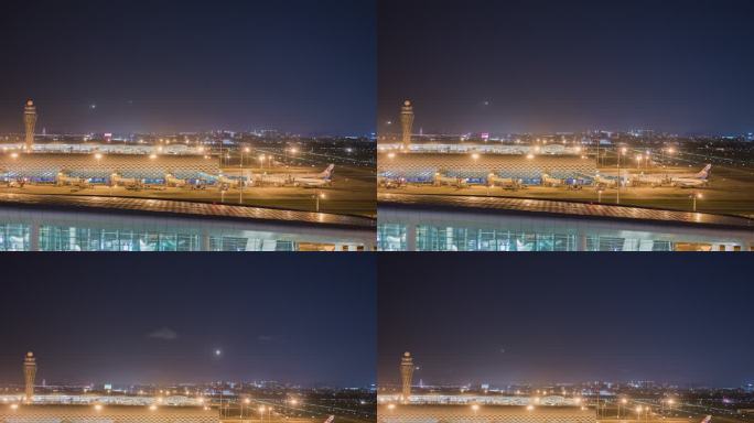 夜晚深圳机场航站楼和飞机落地灯光轨迹