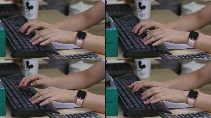 女士戴着手表键盘打字