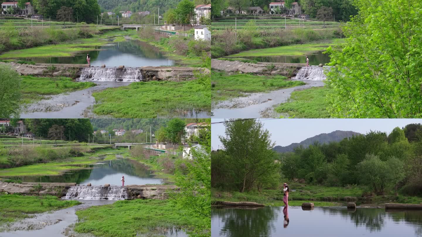 女人在乡间小河瀑布上游玩行走旅行风景航拍