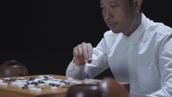 男人思考围棋对局对弈棋子棋盘