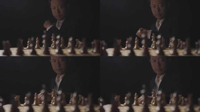 男人坐在国际象棋棋盘前思考