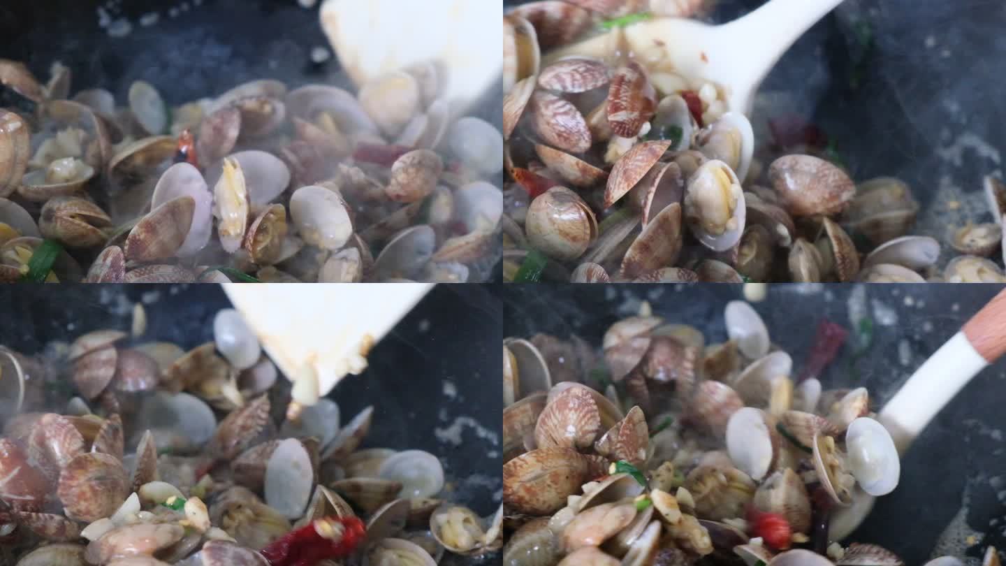 在锅中翻炒蛤蜊海鲜的超慢镜头特写