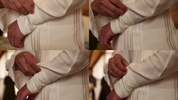 婚礼预备新郎穿衣双手扣扣子白色古典衬衣