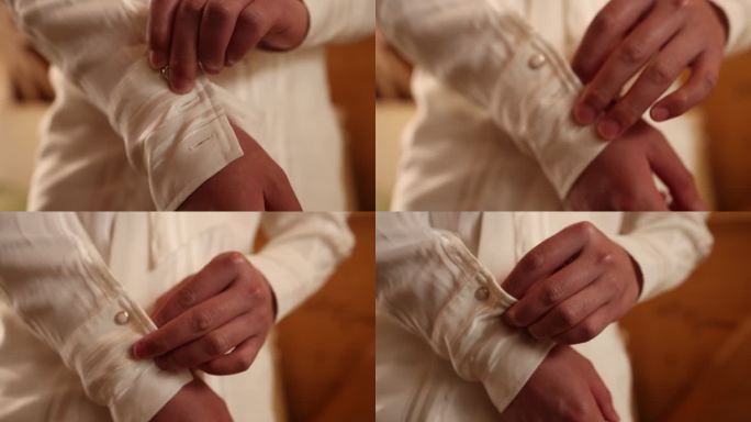 婚礼预备新郎穿衣双手扣扣子白色古典衬衣