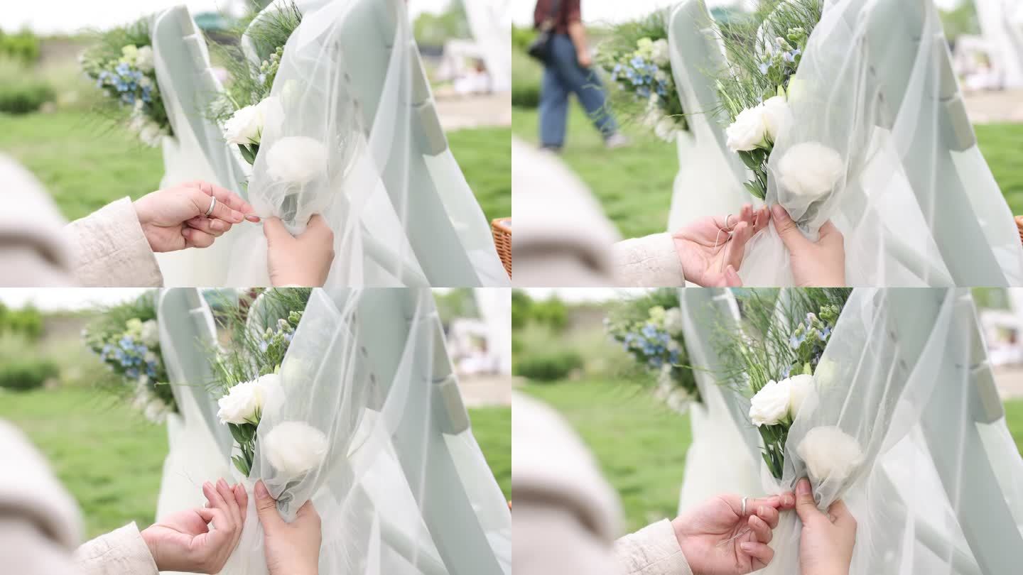 户外婚礼预备椅背装饰白色纱布花朵软饰草坪
