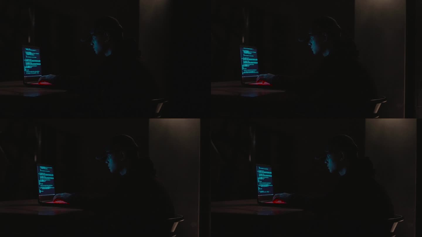 黑暗中男人黑客使用电脑破译程序编码