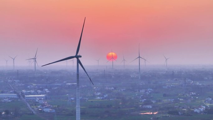 航拍夕阳落日太阳风力发电站群村庄农户平原