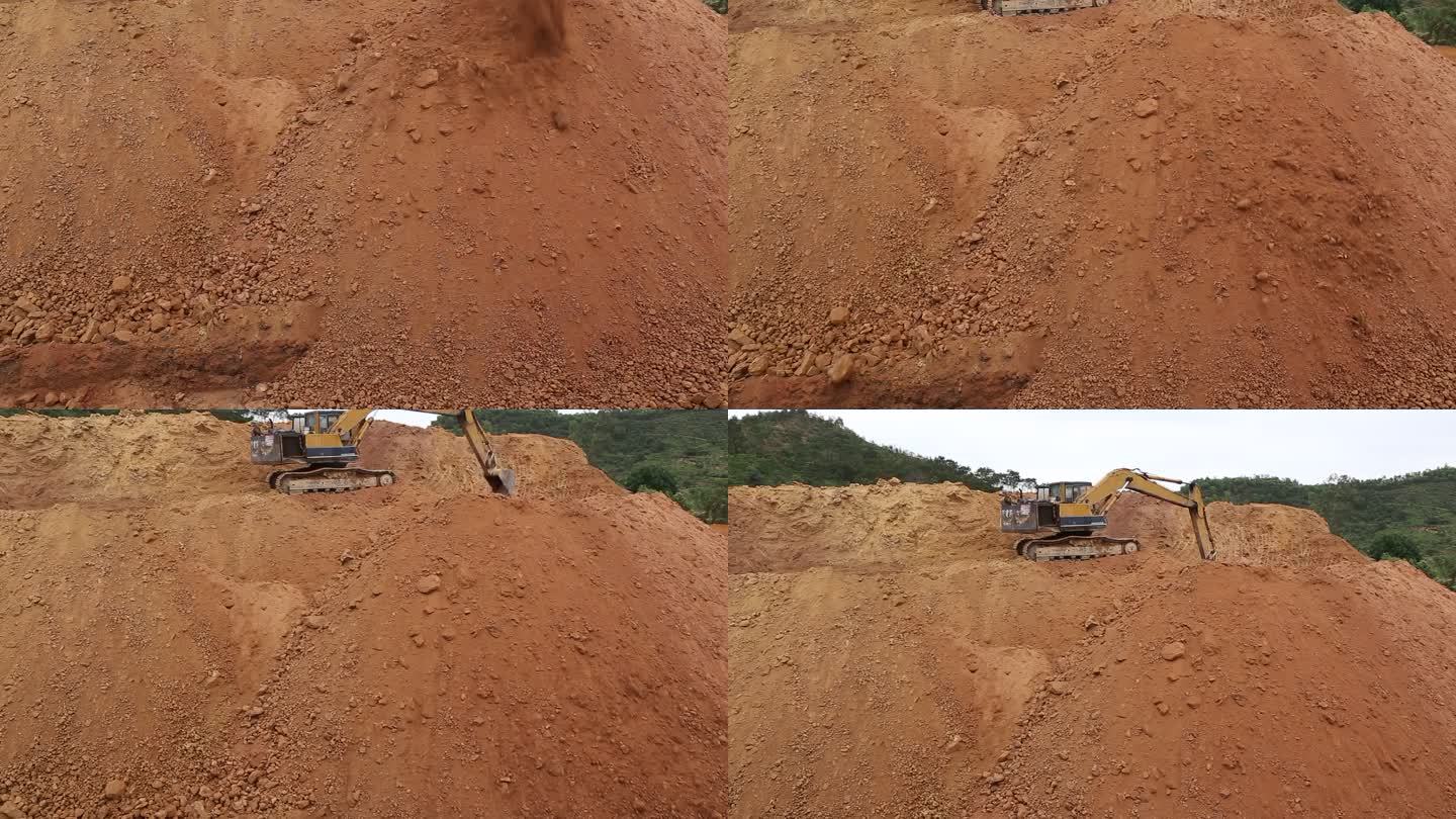 挖土机在高高的土堆上作业