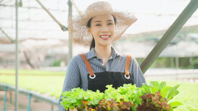 4K实拍亚裔年轻女性农民端着菜篮微笑