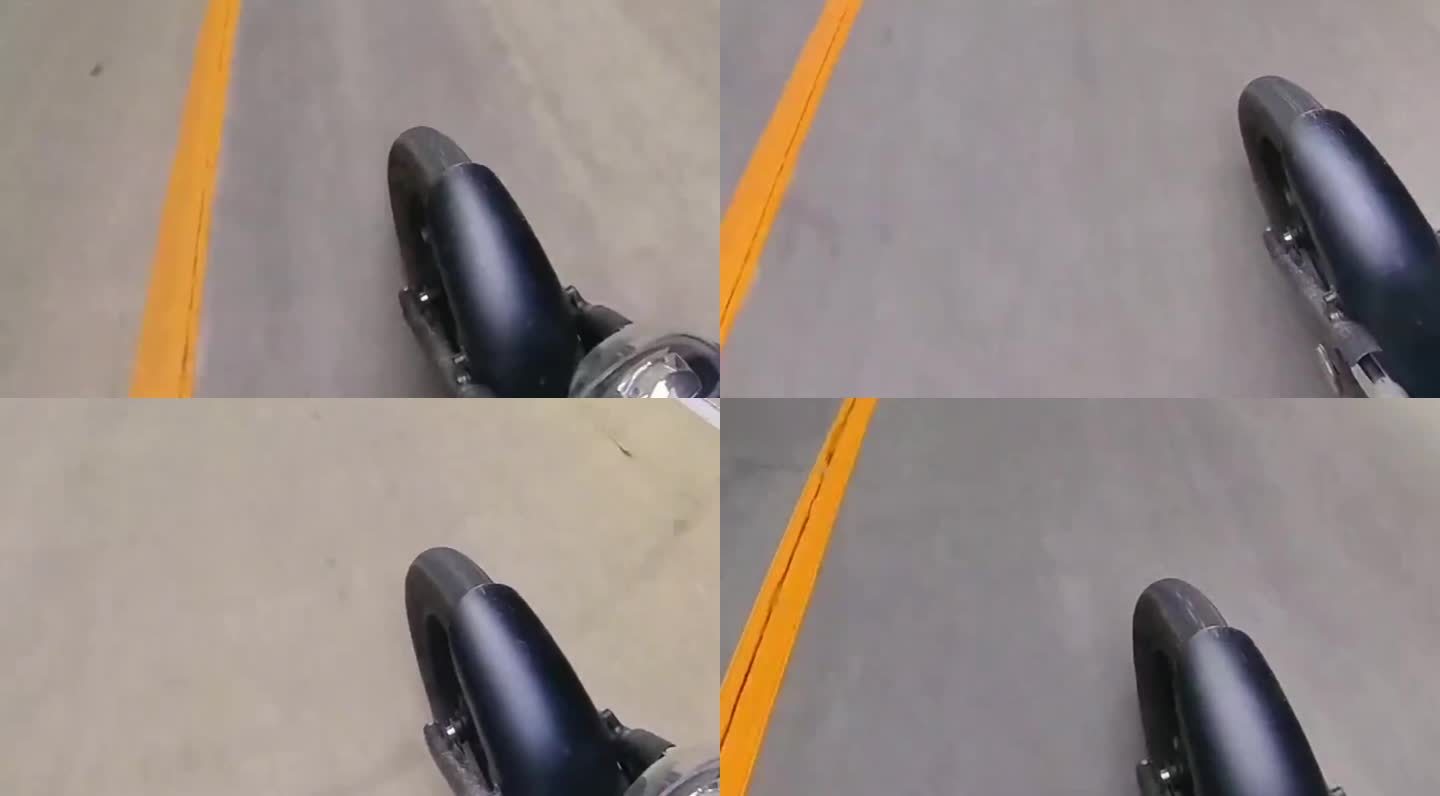 摩托车骑行在路上俯拍斜角前轮特写镜头素材