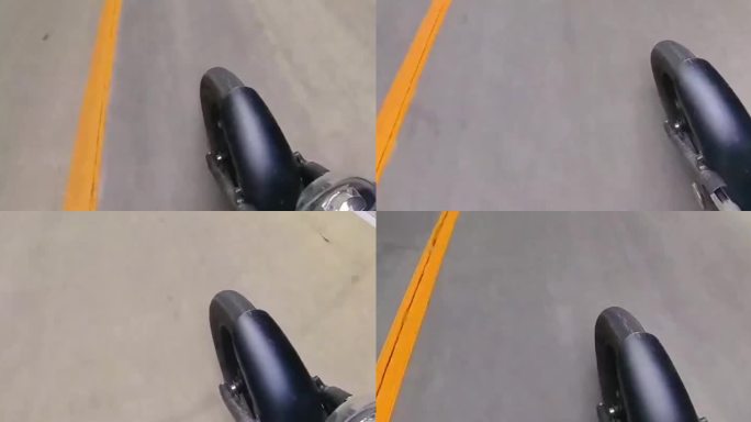摩托车骑行在路上俯拍斜角前轮特写镜头素材