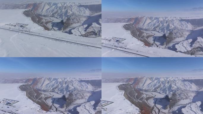 航拍新疆冬季安集海大峡谷红色山脉雪山河流