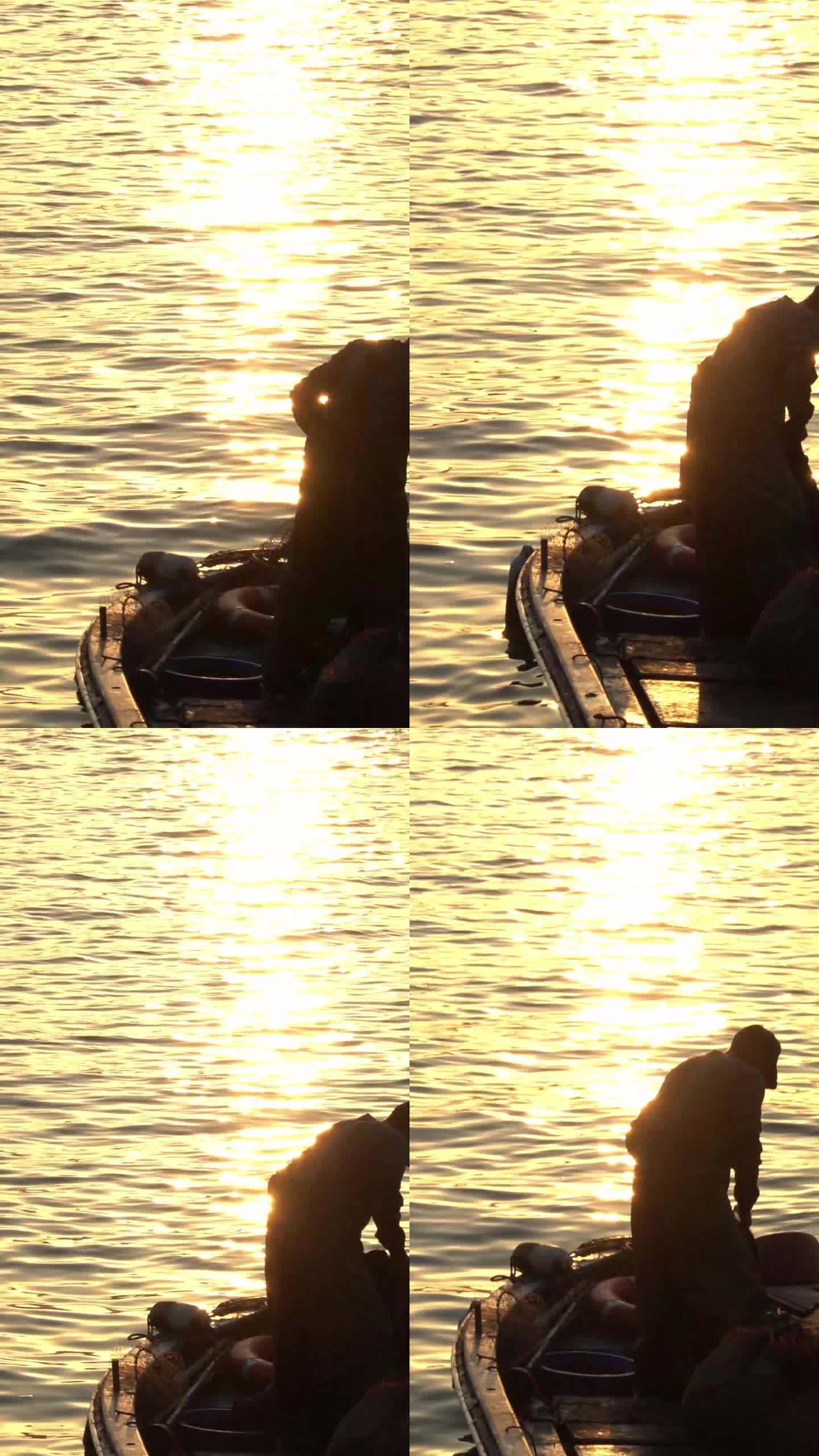 日落时分海上收网的渔民