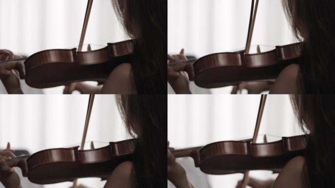 女人演奏小提琴背影