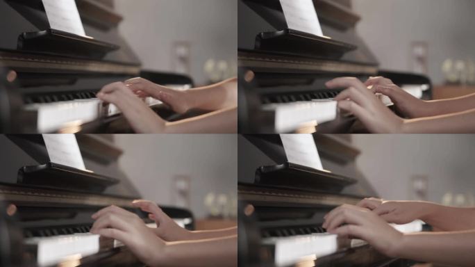 年轻女人手弹钢琴琴键特写