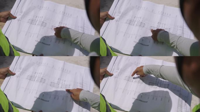 工地建筑设计工程师看图纸走在工地视察工地