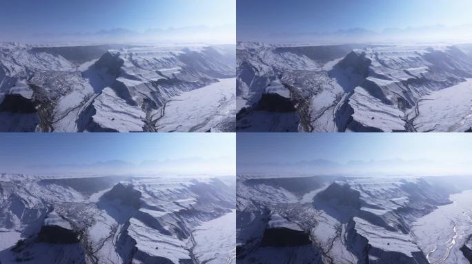 航拍新疆冬季安集海大峡谷红色山脉雪山河流