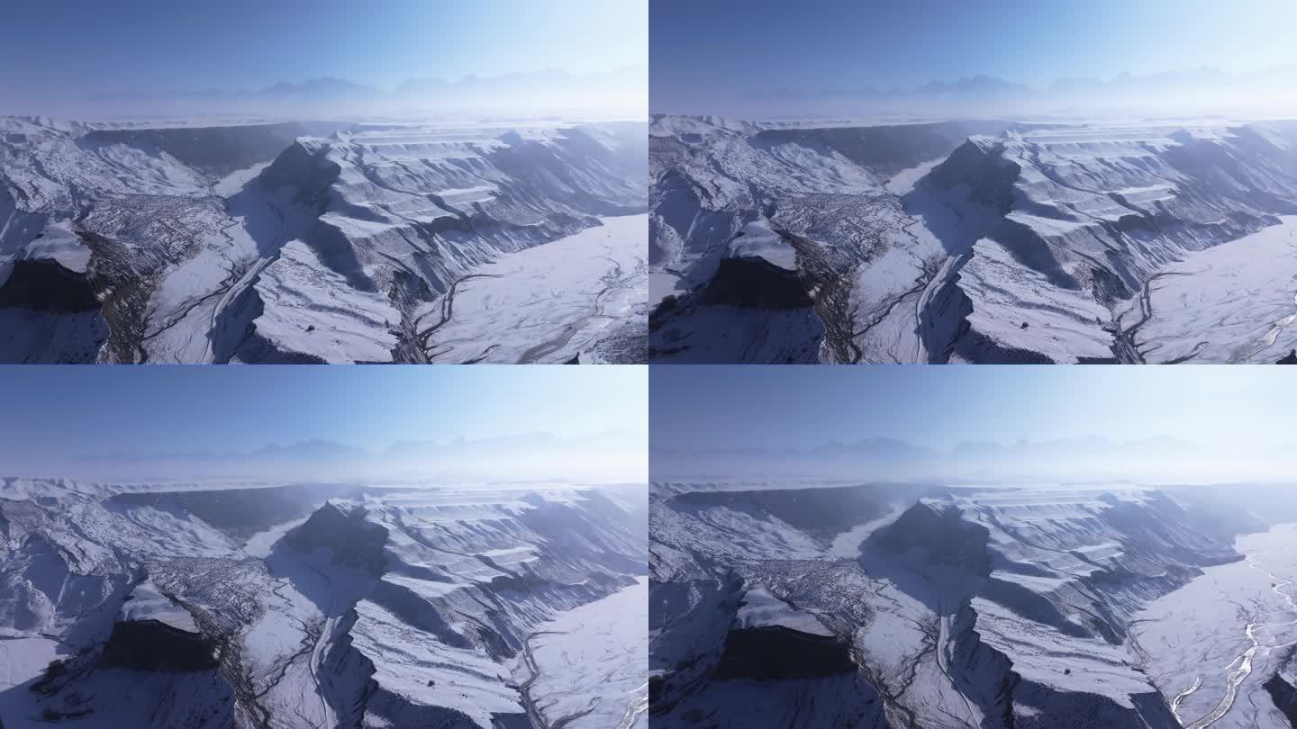 航拍新疆冬季安集海大峡谷红色山脉雪山河流