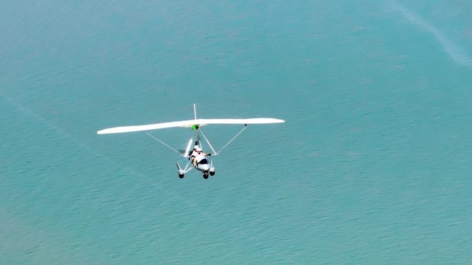 航拍4K滑翔机在海岛上空飞翔