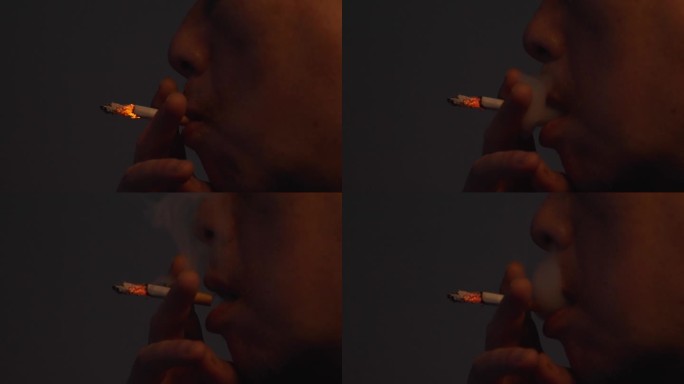 男人吸烟吐烟雾