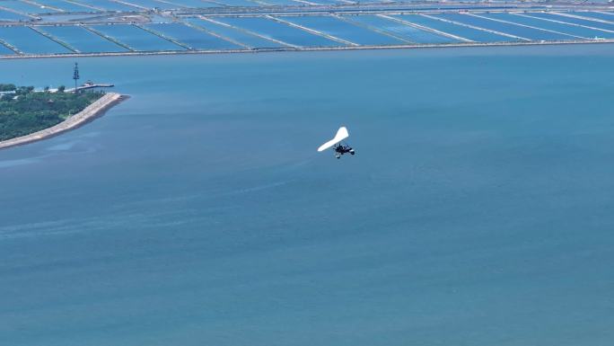 航拍4K滑翔机在海岛上空飞翔