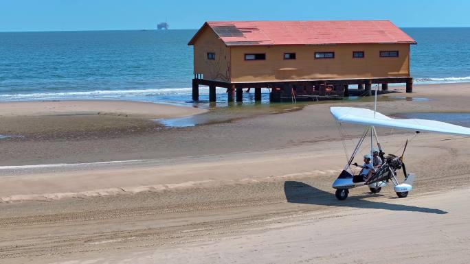 航拍滑翔机在海边沙滩滑行