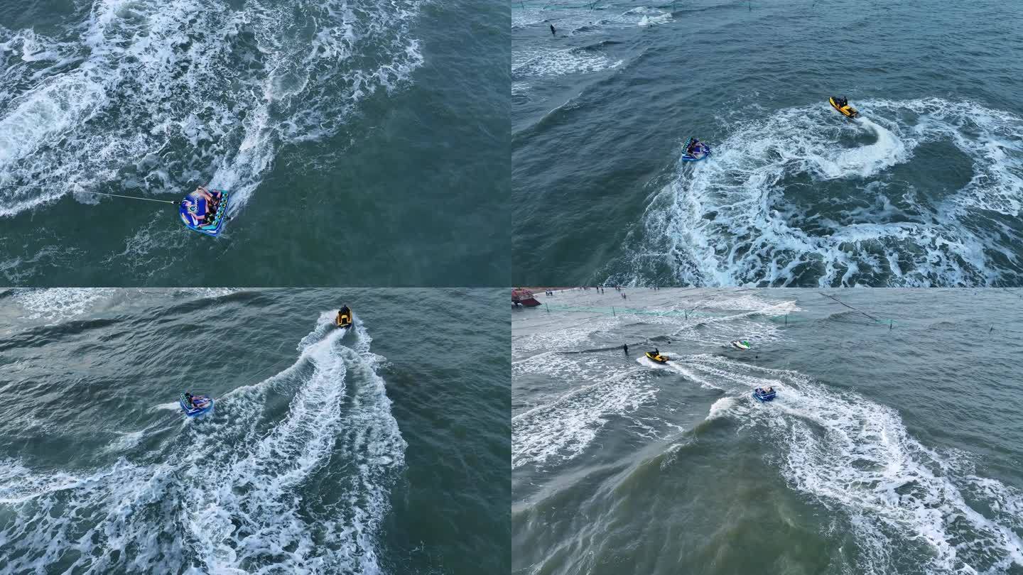 海边度假游客游玩水上项目摩托艇拖拽充气沙发